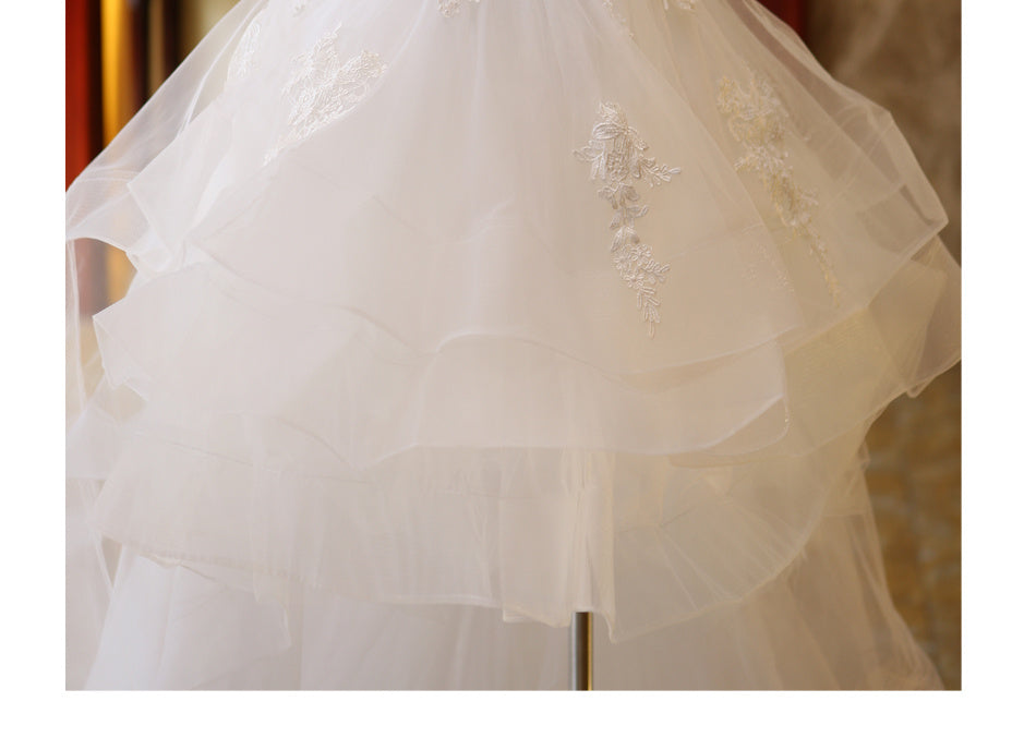 The Bride'S Wedding Dress With Long Tail In Front Of The Studio